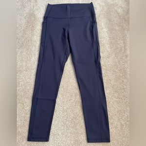 Ziya Active size 8-10 navy blue leggings with side pockets.